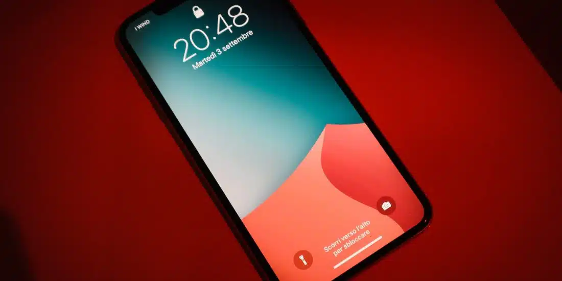 a close up of a cell phone on a red surface