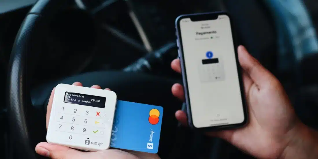 a person holding a credit card and a mobile phone